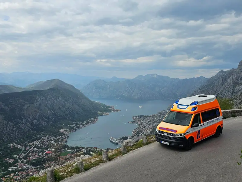 Ambulance on the road above Kotor with the bay and cruise port below
